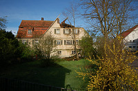 Ansicht des Gbeäudes von Osten. Zum Garten hin eröffnen sich die Räume in den Obergeschossen mit einer symmetrisch gegliederten Fassade, welche durch leichte Vorstöße auf profilierten Vollholzschwellen über dem Obergeschoss und über dem 1. Dachgechoss auskragen. Der südlich angebaute Anbau mit einem Mansarddach ist ebenfalls primär zum Garten hin orientiert. / Haus Osiander in 74549 Wolpertshausen-Rudelsdorf (05.04.2004 - Schäfer, Ferdinand M. (SCHÄFER.PARTNER PartG Architur.Städtebau.Denkmalpflege, Schwäbisch Hall))