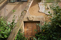 Im westlichen Drittel der Süd-Außenwand, zum Hofinneren hin, findet sich ein aufwändiges
Werksandstein-Gewände aus gelbem Sandstein für eine breite Türe. Der Sturz sowie die
umfassenden Oberflächen der Flanken sind mit großem Scharriereisen gleichmässig egalisert. Die Flanken sind zudem mit weiteren Profilen besetzt. Über der Tür ist das vollplastische Relief eines doppelköpfigen Reichsadlers (ohne Bekrönung) überliefert. In der rechten Klaue ist der Ansatz eines Schwertes zu erkennen. Die linke Hälfte des Reliefs macht den Anschein, als sei sie nie fertiggestellt worden oder sie wurde später mit Ergänzungsmaterial großflächig überarbeitet. Das Herrschaftssignet ist in der hohenloher Hochebene tendeziell heraldisch eher unüblich. / Haus Osiander in 74549 Wolpertshausen-Rudelsdorf (05.04.2024 - Schäfer, Ferdinand M. (SCHÄFER.PARTNER PartG Architur.Städtebau.Denkmalpflege, Schwäbisch Hall))